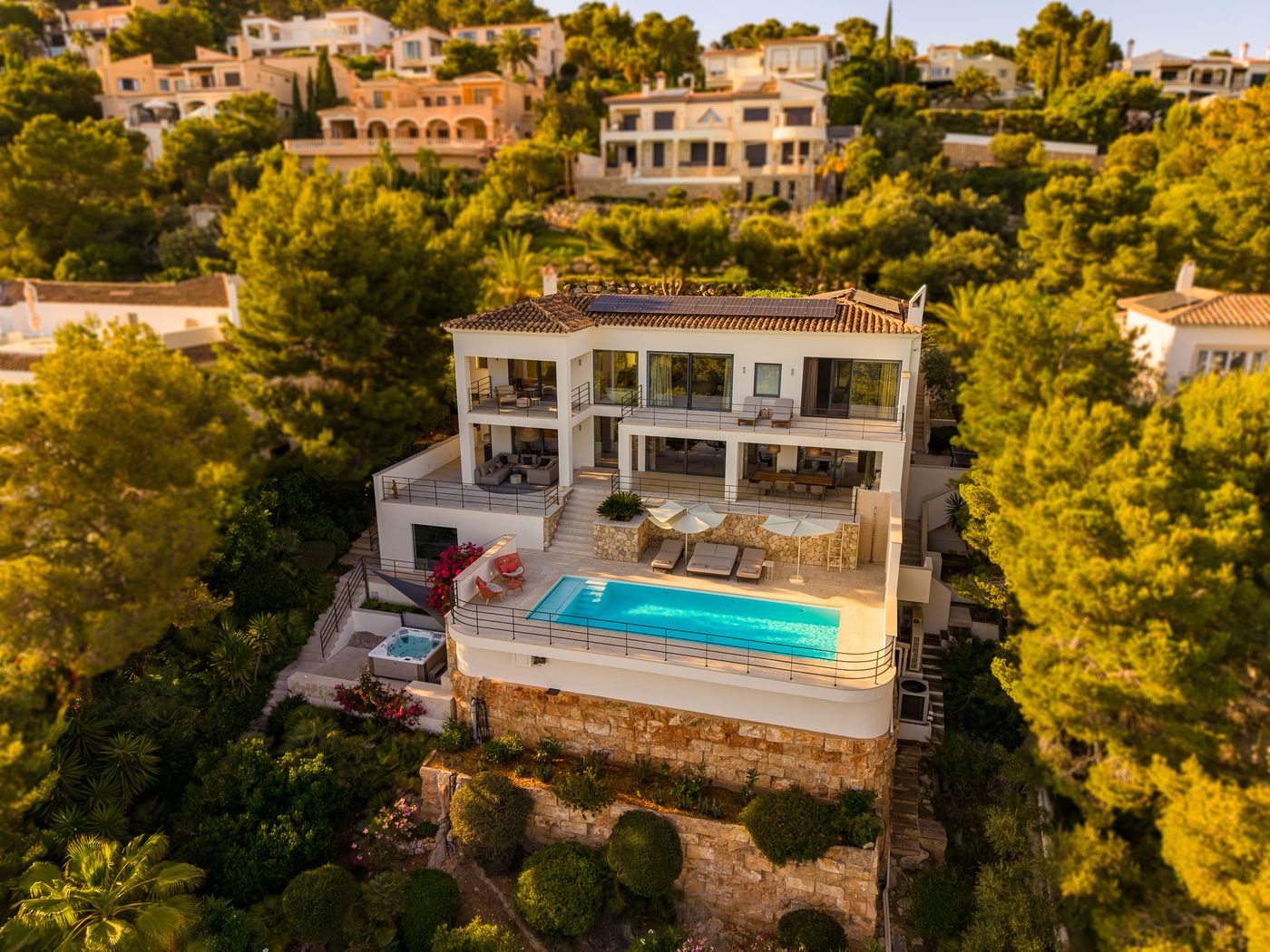 Villa Monport seen as a whole from above — house, terraces, pool and gardens