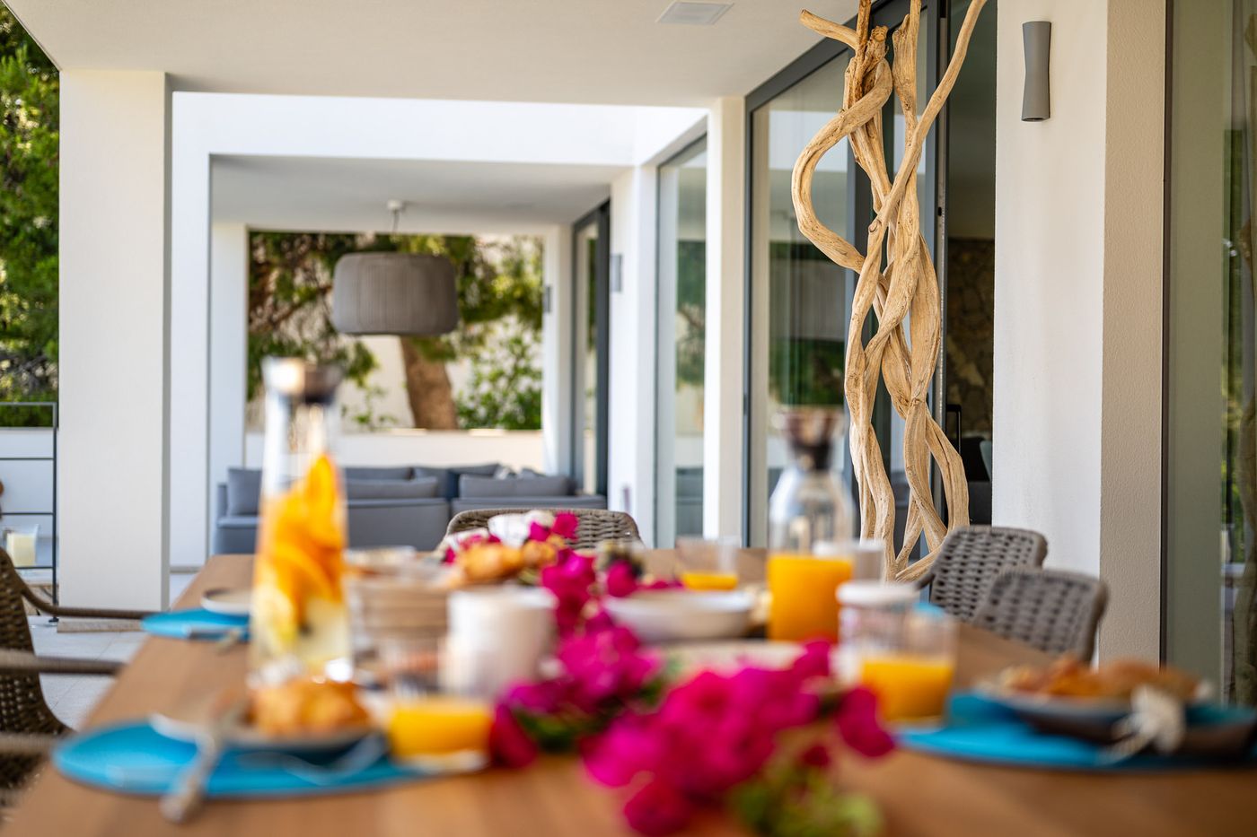 Breakfast laid out on the sea-view terrace with bougainvillea