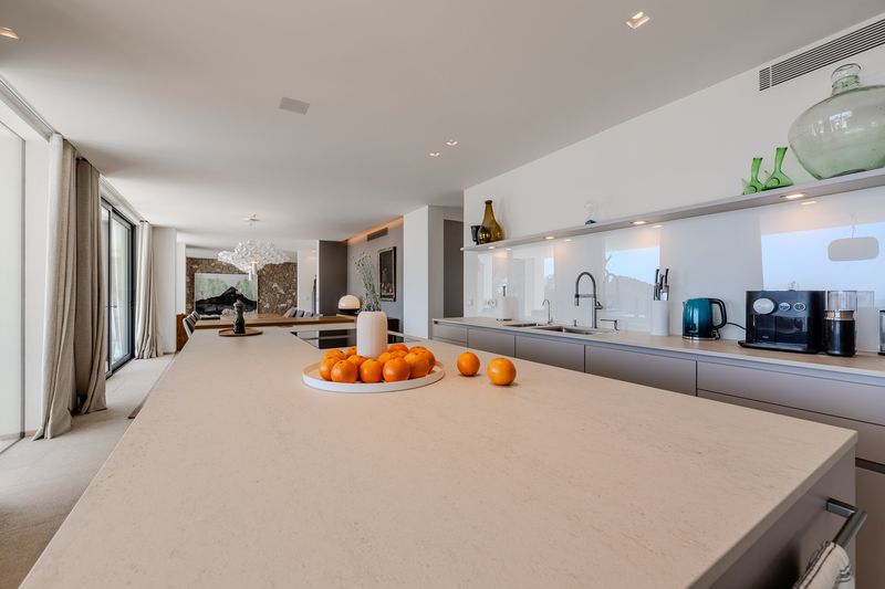 Bright white kitchen with stone island