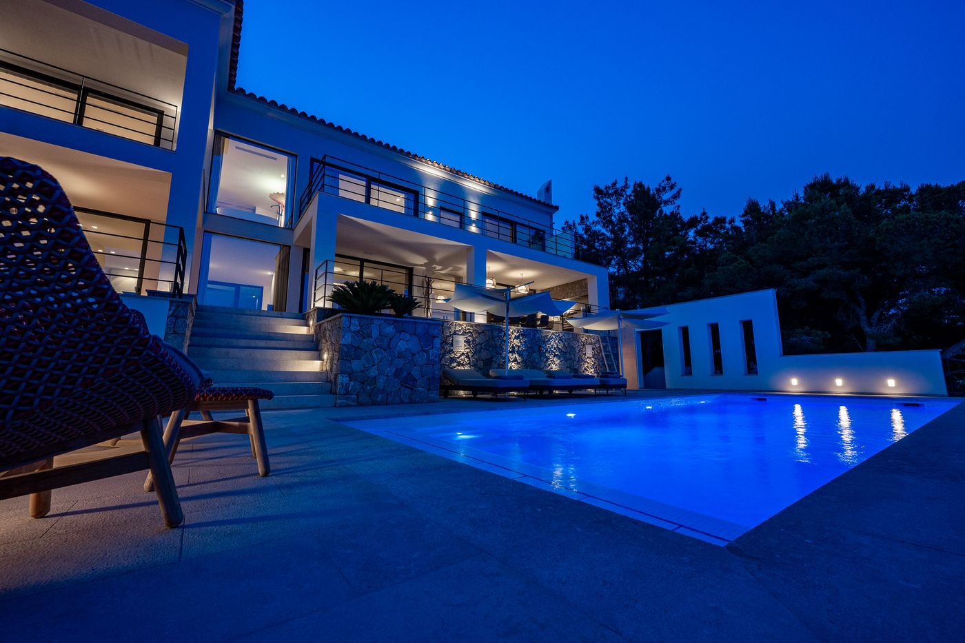 Infinity pool glowing at blue hour